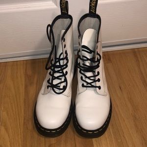 White Dr. Marten combat boots.